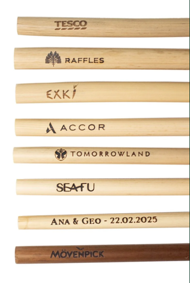 Reed straws branded with corporate logos including Tesco, Raffles, Accor, Tomorrowland and Movenpick